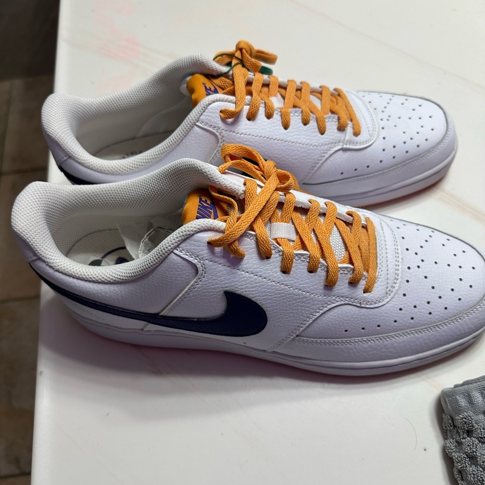Nike White Low-Top Sneakers with Navy Swoosh and Yellow